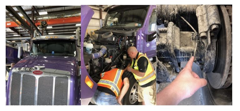 A purple semi-truck in a garage, two workers inspecting the engine, and a hand pointing at a worn part on the truck’s wheel assembly.